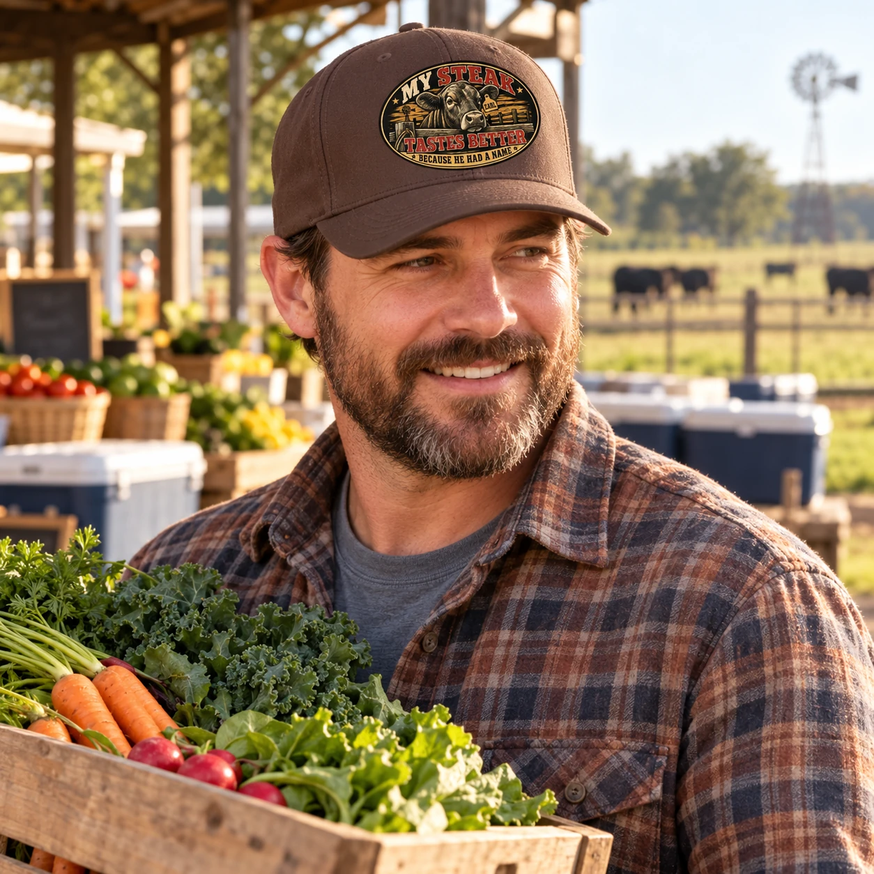 Man wearing the brown My Steak Tastes Better Flexfit cap at a farm stand beside cattle pasture