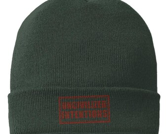 Dark green Uncivilized Intentions cuffed beanie with its subtle oxide-red stamp embroidery visible