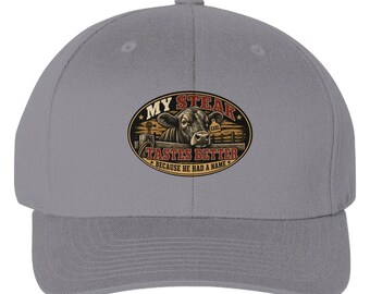 Grey My Steak Tastes Better Flexfit cap with the centered oval patch visible